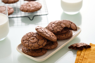 Soft dark chocolate brownie cookies on white backround.