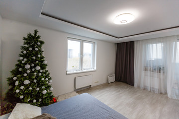 Illuminated Christmas tree decorated in modern living room