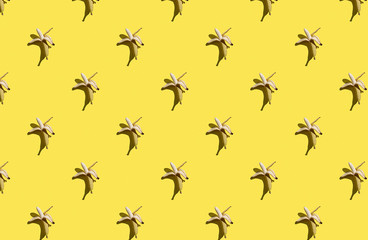 Trendy sunlight Summer pattern made with banana on bright light yellow background. Minimal summer concept.