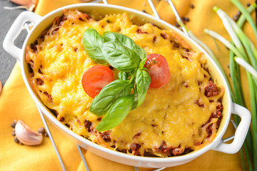 Baking dish with tasty beef casserole on table