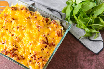 Baking dish with tasty beef casserole on color background