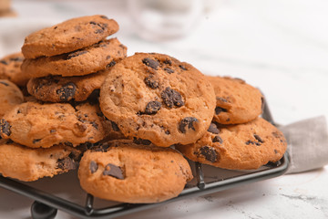 Tasty cookies with chocolate chips on table