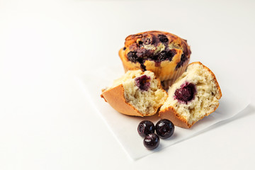 Delicious blueberry muffins and blueberries on a white table. selective focus