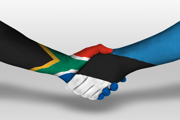 Handshake between estonia and south africa flags painted on hands, illustration with clipping path.