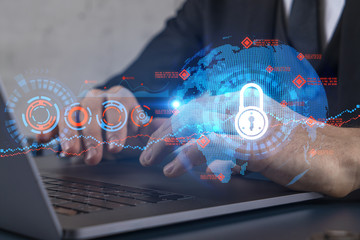 Businessman search for security options, typing laptop background and lock icons hologram.