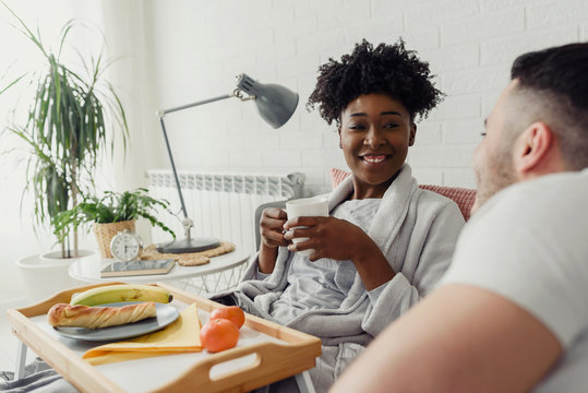 Young multiracial love couple having breakfast in bed - Powered by Adobe