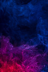 Fototapeta na wymiar Conceptual image of multi-colored smoke isolated on dark black background, Halloween design element.
