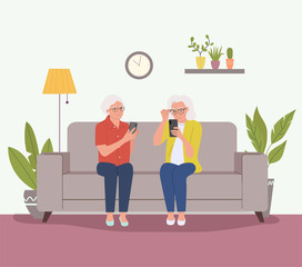 Elderly women are sitting on the sofa with smartphones. Vector flat cartoon style illustration