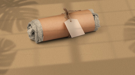 Apparel Packaging Mockup – Rolled T-shirt with Paper Tag