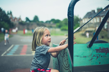 Preschooler climbing on equipment in playground