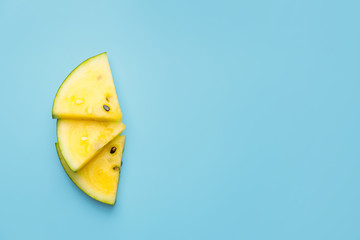 Cut yellow watermelon on color background