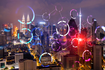 Fototapeta na wymiar Abstract technology icons, night aerial panoramic cityscape of Kuala Lumpur, Malaysia, Asia. The concept of innovative approach to optimize international business process. Double exposure.