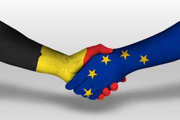 Handshake between european union and belgium flags painted on hands, illustration with clipping path.