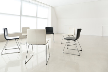 Empty chairs prepared for group therapy in psychologist's office