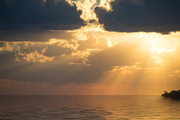 Naklejka na ściany i meble Seascape with a beautiful sunset and sun rays