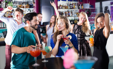 Young students dancing on party with a cocktails at a club