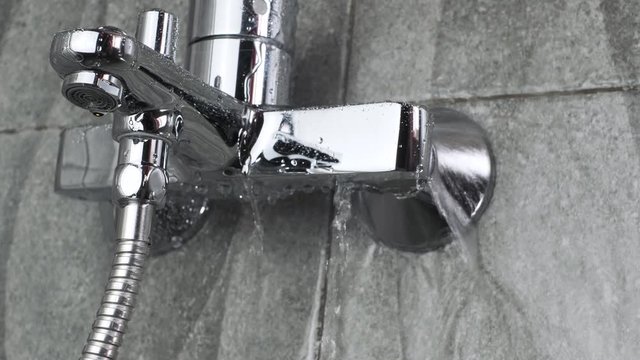 Bathroom leak. Close up  a water leaking tap Faucet,  hous keep work fix leak