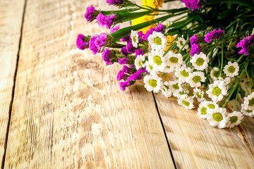 Spring flowers on wooden board