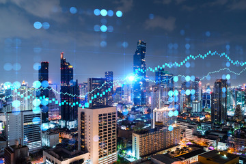 FOREX graph hologram, aerial night panoramic cityscape of Bangkok, the developed location for stock market researchers in Asia. The concept of fundamental analysis. Double exposure.