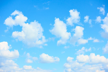 Naklejka na ściany i meble Light blue sky with beautiful white clouds