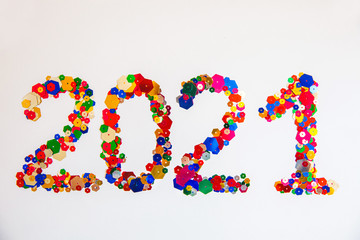 2021 made of confetti on white background. New Year idea