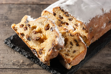 Christmas stollen fruit cake on wooden table.Close up	