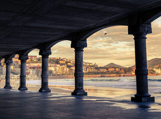 first lights of day in the arcades of la cocha beach in san sebastian, spain