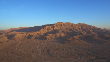 Fototapeta na wymiar Luxor Egypt panorama view riding hot air balloon over valley of the king sunrise aerial view video