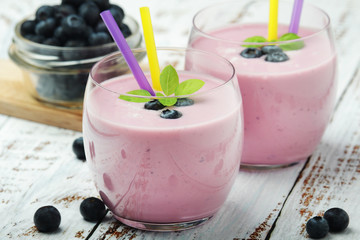 Two glasses with blueberry yogurt	