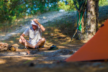 A tourist throws small chips into the fire.