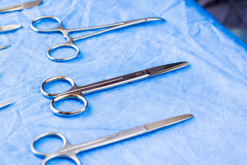 Surgical scissors on the blue sterile table