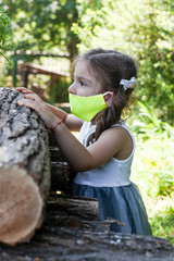 Little girl in a protective face mask