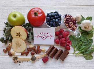 Naklejka na ściany i meble Foods for healthy heart. Assortment of natural products to prevent heart disease. The best foods to protect heart and blood vessels: green tea, garlic, berries, nuts, spinach, apple, chia, hemp seed..