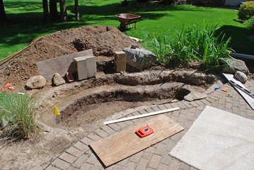 Pond/waterfall project being constructed by the homeowner at the edge of the patio.