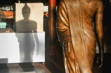 Fototapeta na wymiar The standing buddha's shadow at Wat Intharawihan in Bangkok Thailand 