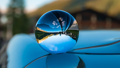 Crystal ball alpine landscape shot on a car roof with reflections at the famous Hintertuxer Gletscher, Tyrol, Austria