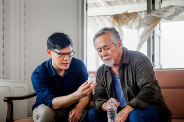 Middle aged son takes care of sick senior father, Happiness Asian family concepts