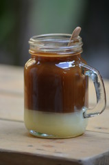 Close up of a glass cup with a capuccino
