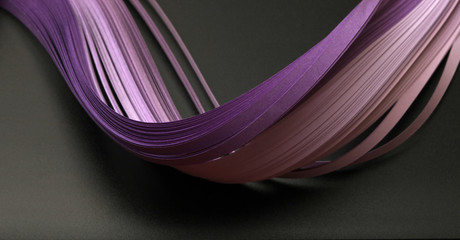  Violet (lilac) color strip wave paper. Abstract texture black background.