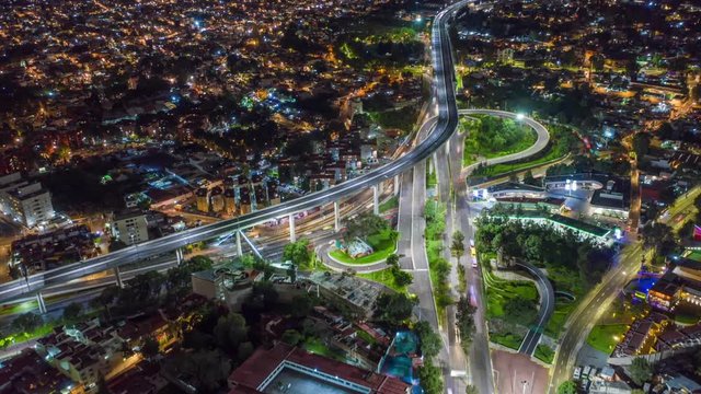 Aerial hyperlapse hover Mexico City with highway lights at night