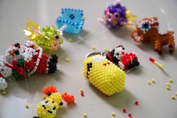 Handcrafted small bead dolls and keychain, colorful cute small handmade beaded dolls and keychain.
