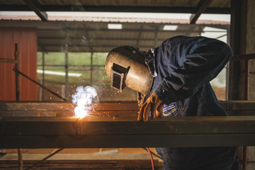 El Oro / Ecuador - 2017 : A welder at his job, welding metal bars together