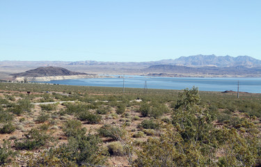 Fototapeta na wymiar lake scenery of desert has many rock mountains 