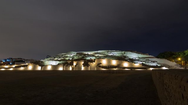 Pyramid of Huaca Pucllana day to night transition timelapse, pre Inca culture ceremonial building ruins in Lima, Peru. Clouds on a sky. Illumination is turning on
