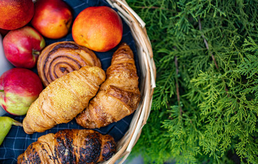 top view of a basket with fruit and buns. 