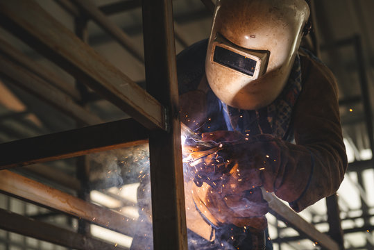 El Oro / Ecuador - 2017 : A welder at his job, welding metal bars together