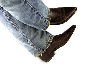 People wearing blue jeans, brown leather boots on white background.