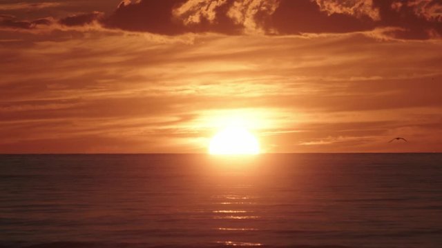 Dramatic orange sunset over the Sea.