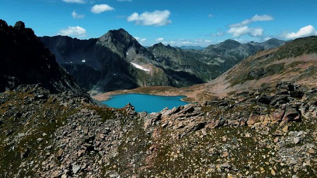 Alpine blue lake at the top of the ridge. Aerial photography