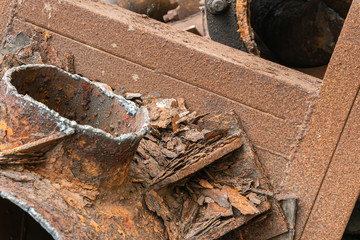 Heap of old aged useless rusty rough and rotten water pipes